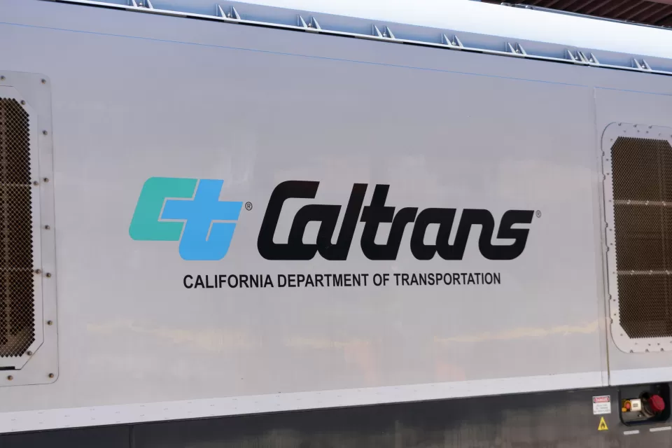 Close-up of Caltrans logo on white passenger train